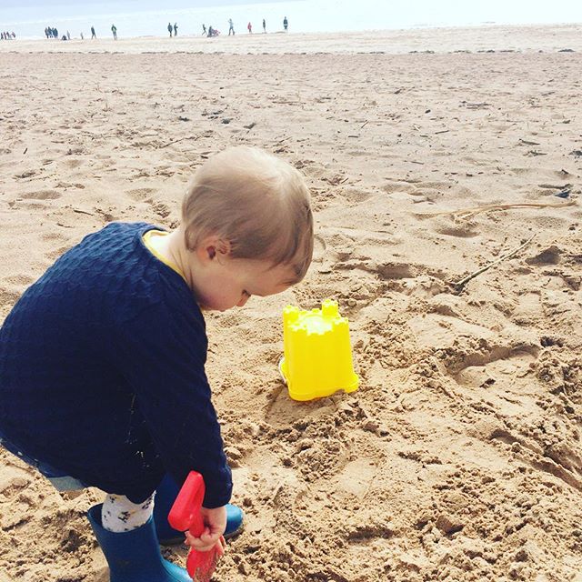 A girl and her yellow bucket, playing in the sand this afternoon. She wasn't very keen on going anywhere near the sea after her little swim yesterday!